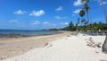 Walking on the beach near resort under palm trees on white sand Phra Ae long beach of Koh Lanta island, Krabi, Thailand. Small wav