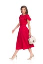 Walking Beautiful Woman In Red Dress, Gold High Heels And Beige Purse Royalty Free Stock Photo