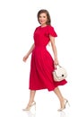 Walking Beautiful Woman In Red Dress, Gold High Heels And Beige Purse Royalty Free Stock Photo