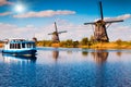 Walking boat on the famous Kinderdijk canal with windmills Royalty Free Stock Photo