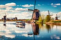 Walking boat on the famoust Kinderdijk canal with windmills. Old Dutch village Kinderdijk, UNESCO world heritage site. Netherlands Royalty Free Stock Photo