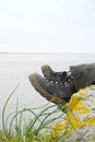 Walking boots with sea in background