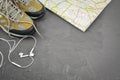 Walking boots on world map and headphones Royalty Free Stock Photo