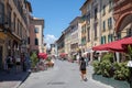 Walking on Borgo Stretto street in Pisa city with historic buildings