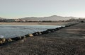 Walking on breakwater with beautiful landscape with mountain and ocean in sunset Royalty Free Stock Photo