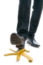 Walking businessman is going to slip on banana peel