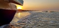 Walking catamaran against the backdrop of sunrise on the sea.