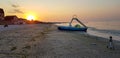 Walking catamaran against the backdrop of sunrise on the sea.