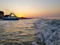 Walking catamaran against the backdrop of sunrise on the sea.