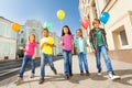 Walking children diversity with colorful balloons Royalty Free Stock Photo