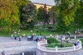 Walking citizens in the Alexander Garden, at the Kremlin Wall, in Moscow, on a warm evening