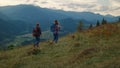 Walking couple hiking mountains. Two travelers going trekking poles in nature. Royalty Free Stock Photo