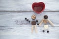 Walking couple made with chocolate cookies. Heart shape ceramic. Concept of friendship, love, marriage, honeymoon, party Royalty Free Stock Photo