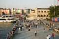 Walking crowd of people on the sunset on the coast of Kadikoy Square Istanbul and The Haldun Taner Theater Building