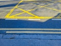 The walking and cycling paths in city are separated from each other with yellow lines. White road markings for pedestrians and Royalty Free Stock Photo