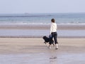 Walking the dog on the beach