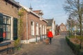 Walking the dog in a historic Dutch village Royalty Free Stock Photo