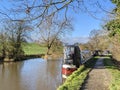 Walking down the canal footpath by the narrowboats Royalty Free Stock Photo