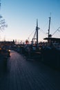 Walking down a small pier at sunset with lots of small boats, Stockholm Sweden Royalty Free Stock Photo