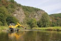 The walking dredger working in the river - river bed restoration