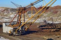 The walking excavator in quarry. Tilt shift picture.