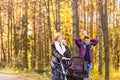 Walking family with two children in autumnal park