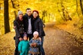 Walking family with two children in autumnal park Royalty Free Stock Photo