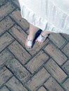 Walking feet in white sandals