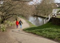 Walking hand in hand by the canal