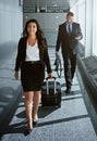 Walking, journey or business people in airport with suitcase, luggage or baggage for a global trip. Smile, happy woman Royalty Free Stock Photo