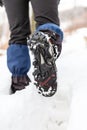Walking legs and shoes on snow trail in winter