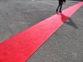 Walking lonely man on red carpet close view on legs