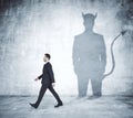 Walking man with devil shadow Royalty Free Stock Photo