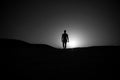 Walking man silhouette at sunset sky Royalty Free Stock Photo