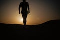 Walking man silhouette at sunset sky Royalty Free Stock Photo