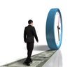 Walking on money way following rolling clock Royalty Free Stock Photo