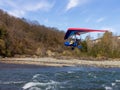 Walking on a motor hang glider along the bed of a mountain river on an autumn sunny day, an unforgettable experience.++