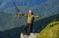 Walking in mountains. Man brutal gamekeeper nature landscape background. Hunting masculine hobby concept. Regulation of