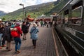 Walking near Flamsbana railroad wagons in Flam with high hills in the background, Vestland, Norway