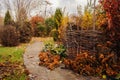 Walking in november garden. Late autumn view with rustic fence