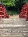 Walking over red wooden bridge Royalty Free Stock Photo