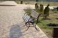 Bench in a city park. Brown bench made of wood. A place to relax. Royalty Free Stock Photo