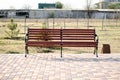 Bench in a city park. Brown bench made of wood. A place to relax. Royalty Free Stock Photo