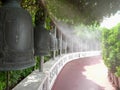 Walking past bronze bells at golden mount in bangkok Royalty Free Stock Photo