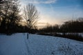 Walking path through the meadows, covered with snow in .a city park in Jette, Belgium