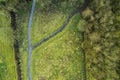 Walking path in a park with green fields and trees. Aerial top down view. Nature scene. Nobody Royalty Free Stock Photo