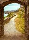 Walking path, trail through arched stone door on a beach Royalty Free Stock Photo