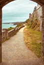 Walking path, trail through arched stone door on a beach Royalty Free Stock Photo