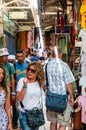 Walking people in ancient Old Town Market of Jerusalem full of shops with all kinds of touristic products like t-shirts, souvenirs Royalty Free Stock Photo