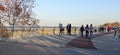 Walking people on the pedestrian-bicycle bridge in Kiev in autumn